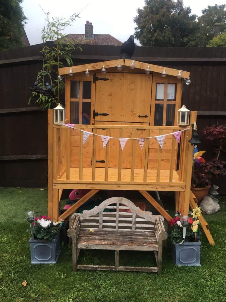 Garden tower playhouse with lamp and bunting decorations