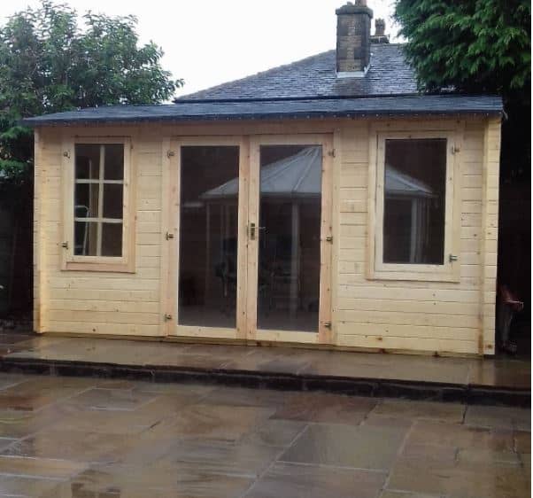 Garden log cabin in the rain