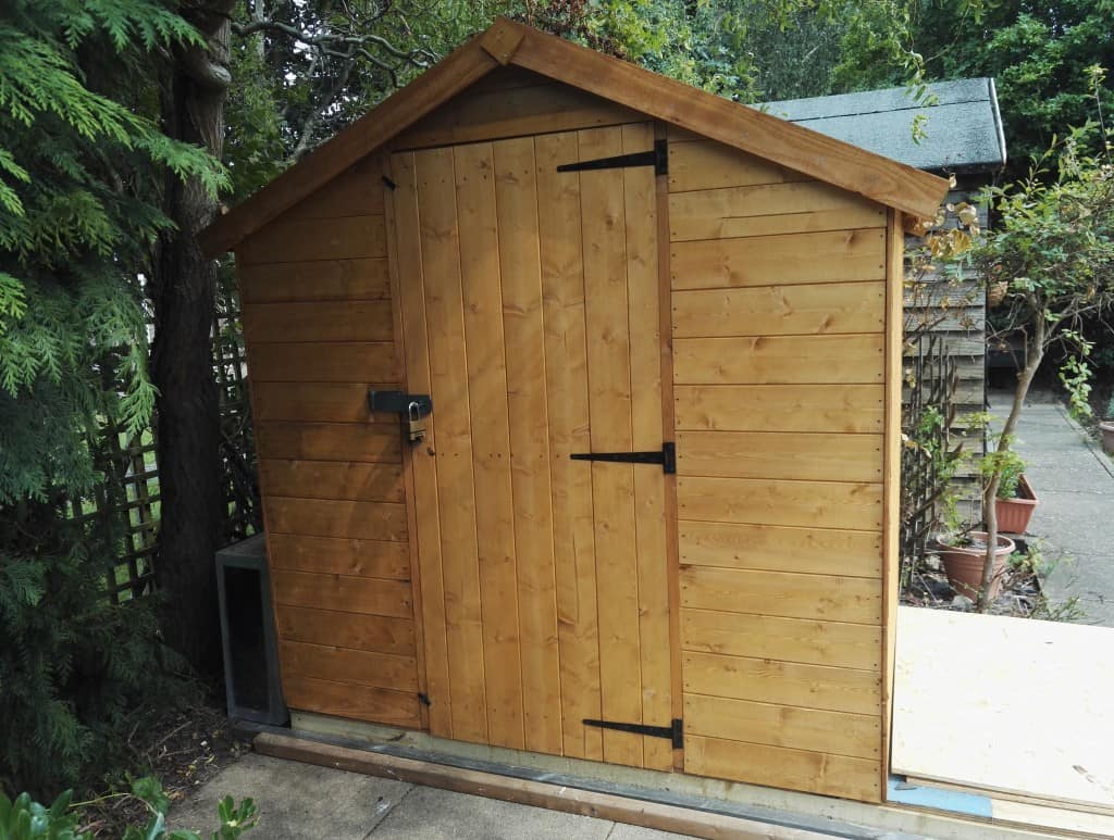 Small storage shed in a tight paved garden