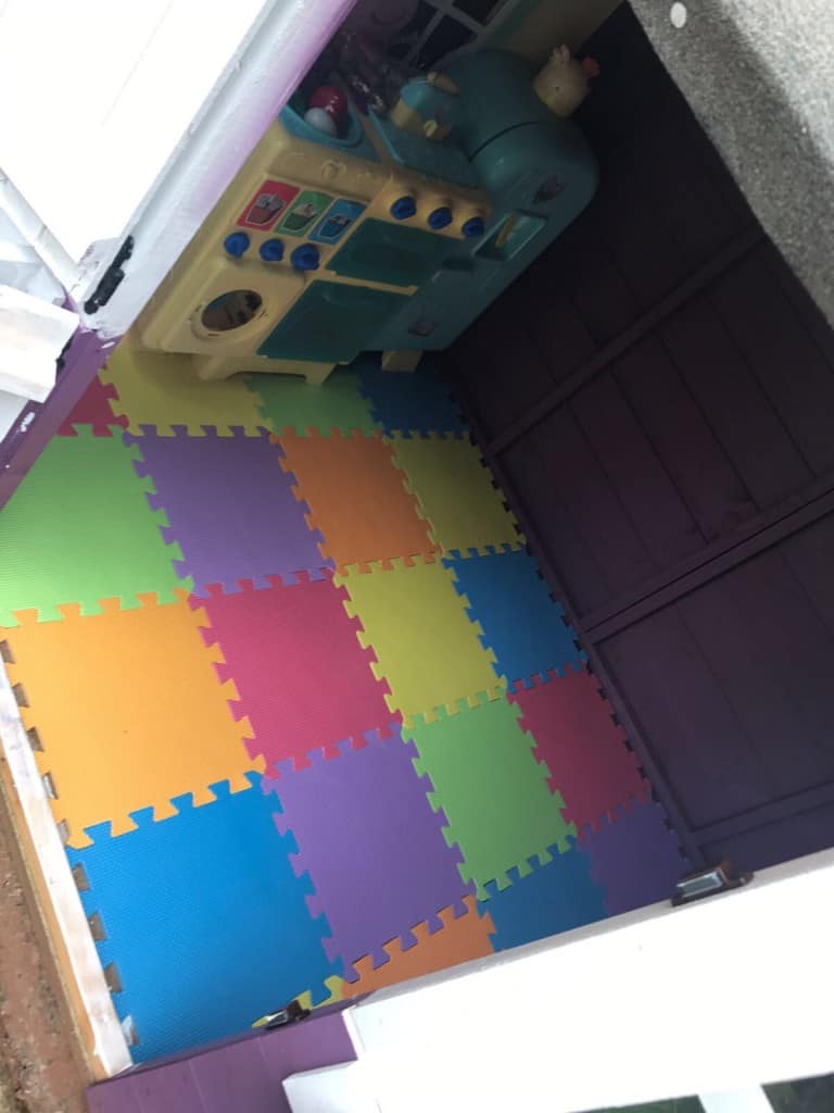 Toy kitchen set inside a small playhouse