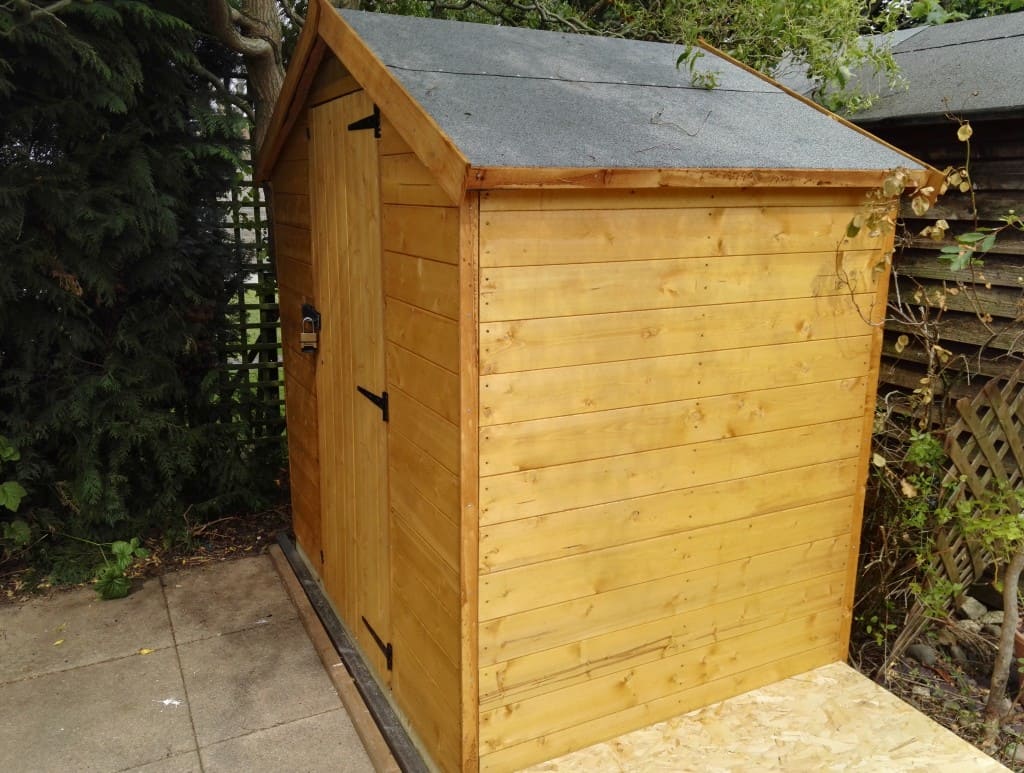 Small storage shed in a tight paved garden